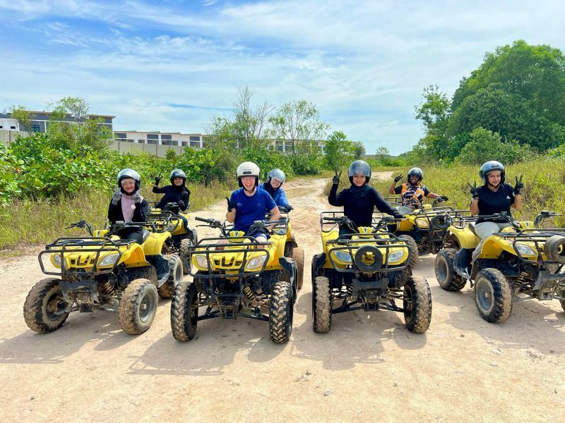 Team members riding ATVs on an outing